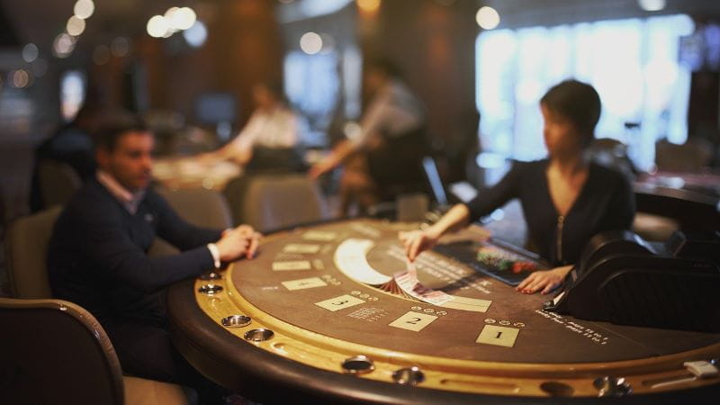 Dealer deals the cards on a casino table.