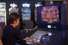 Woman playing a slot machine.