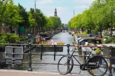 Bicycle looking towards a typical canal in Amsterdam, Netherlands.