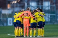 Women's football team making pineapple.